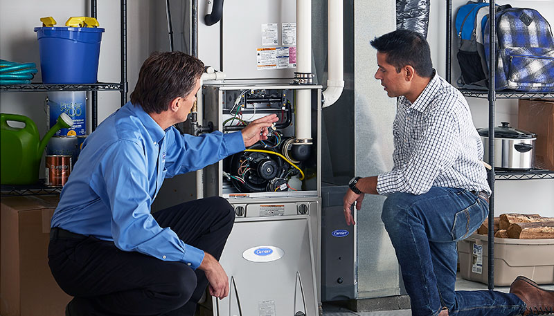 HVAC technician evaluating a furnace for repair or replacement in South Jordan