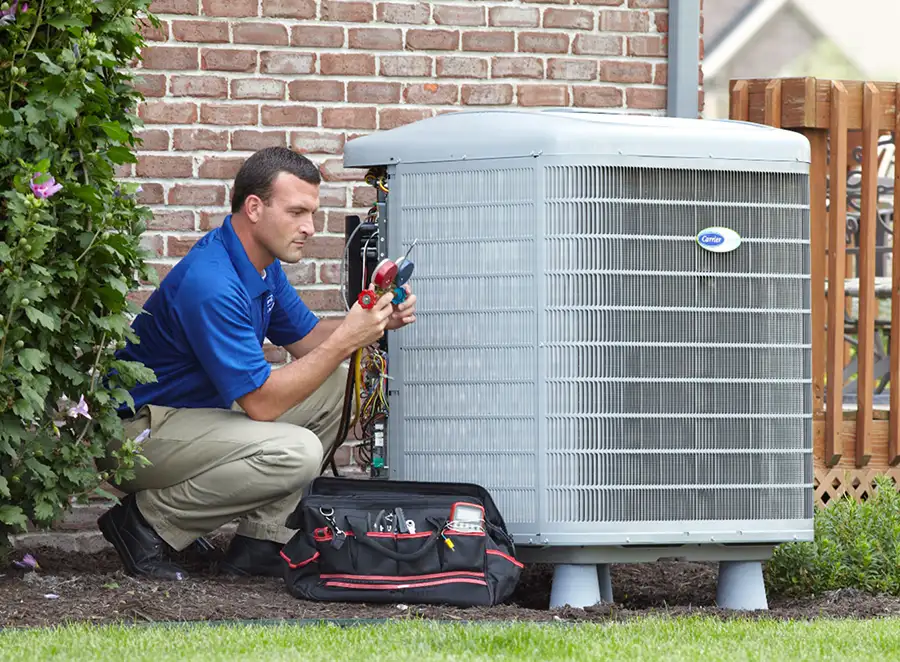 HVAC technician inspecting an outdoor air conditioning unit in South Jordan