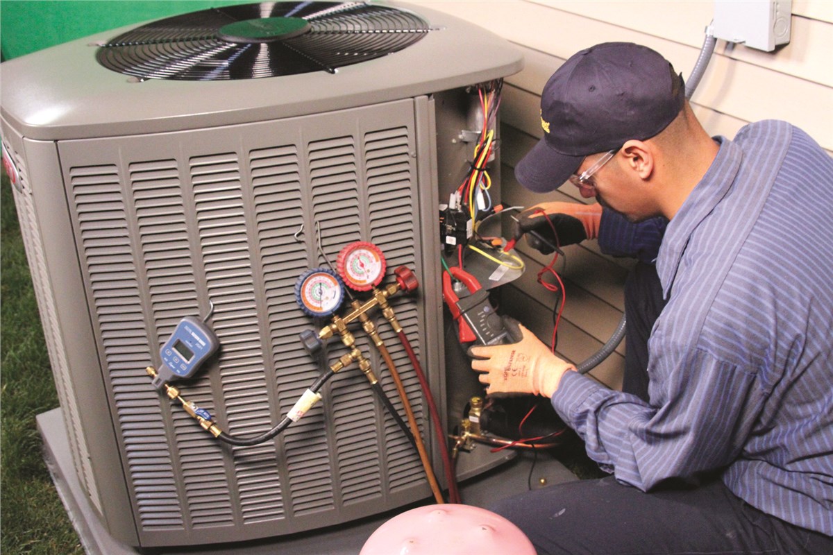 HVAC technician testing an outdoor air conditioning unit in South Jordan