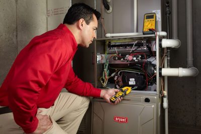 furnace repair Heating and air conditioning technician servicing an indoor furnace in South Jordan, UT